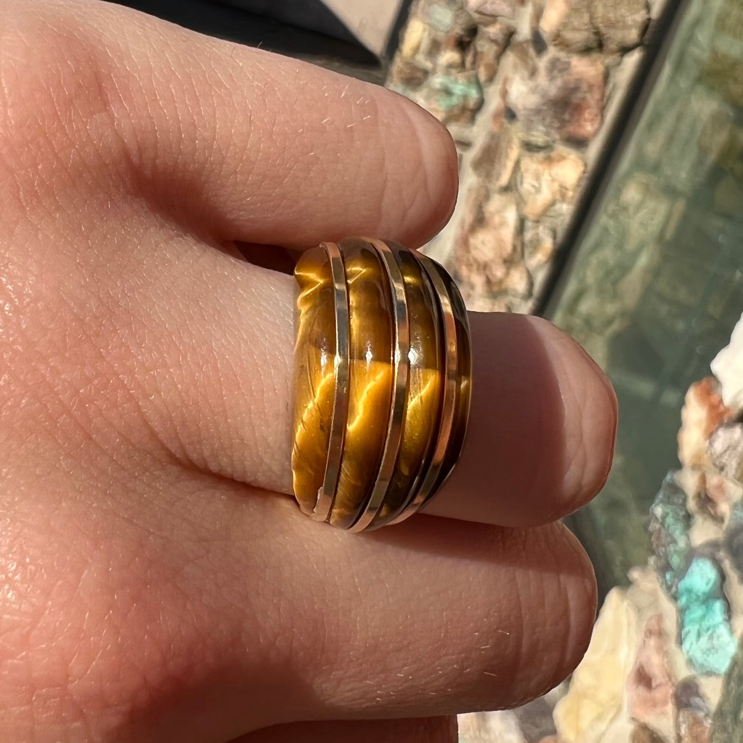 A ladies' high dome carved tiger's eye ring cast in yellow gold.