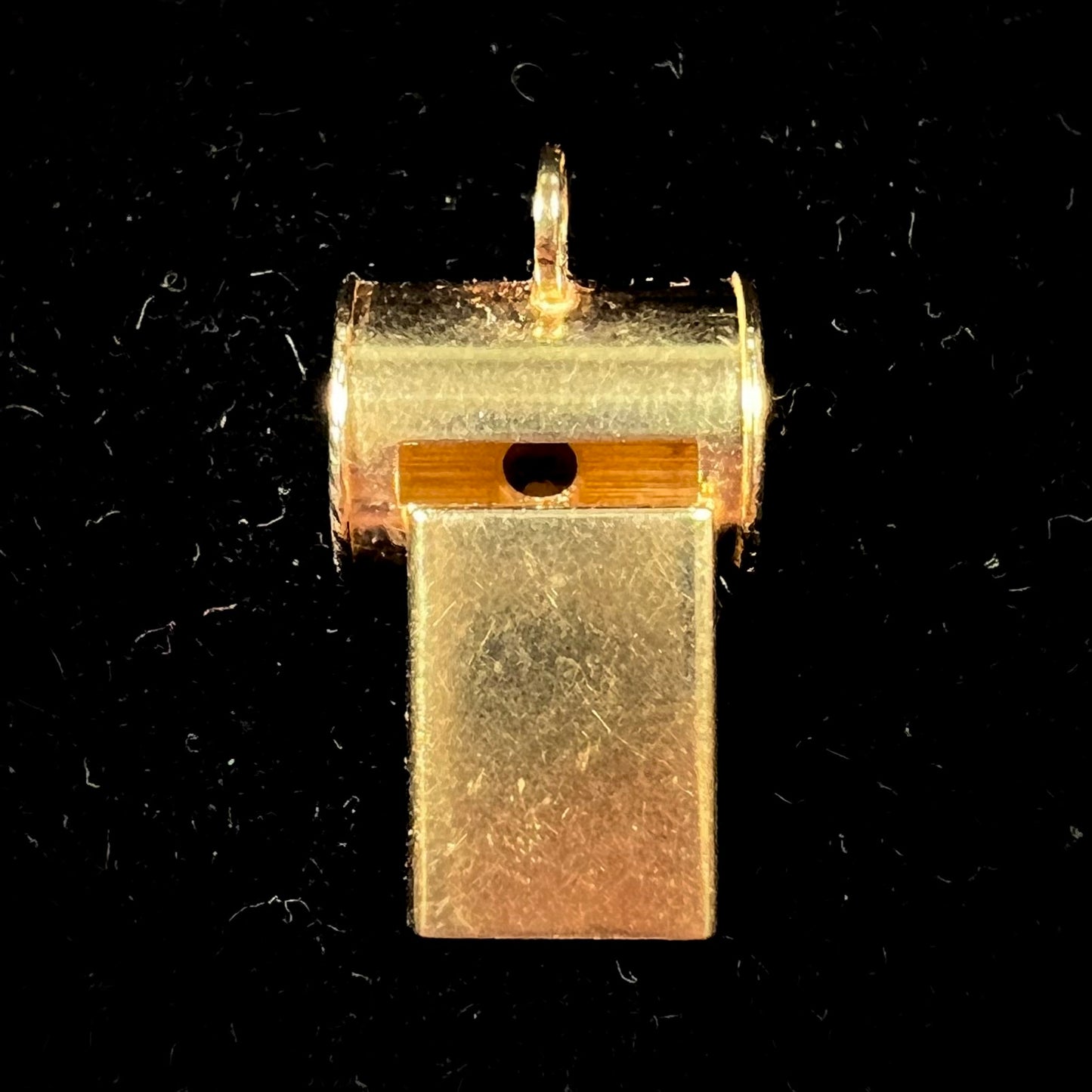 An 18kt yellow gold whistle charm.