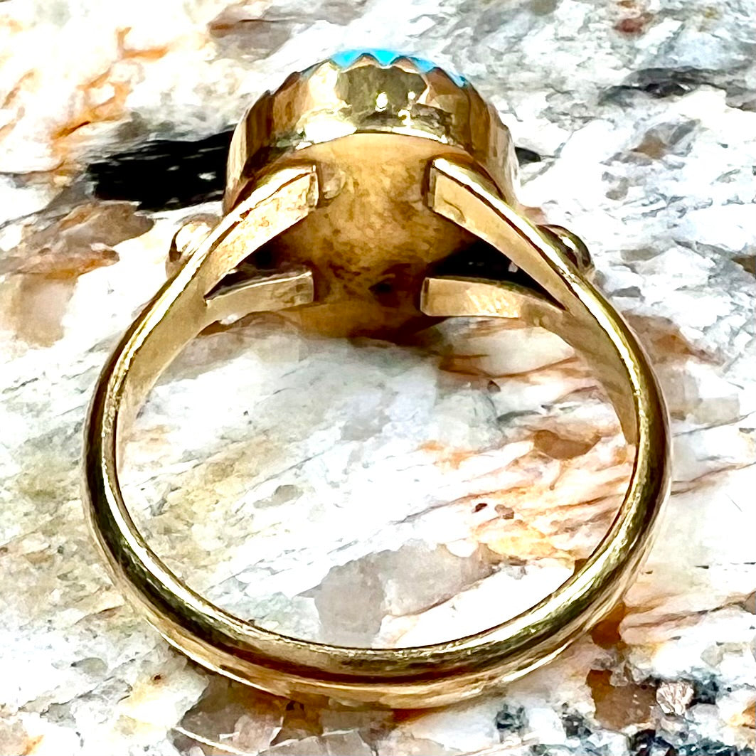 A ladies' yellow gold turquoise ring.  The turquoise is a round cabochon cut.