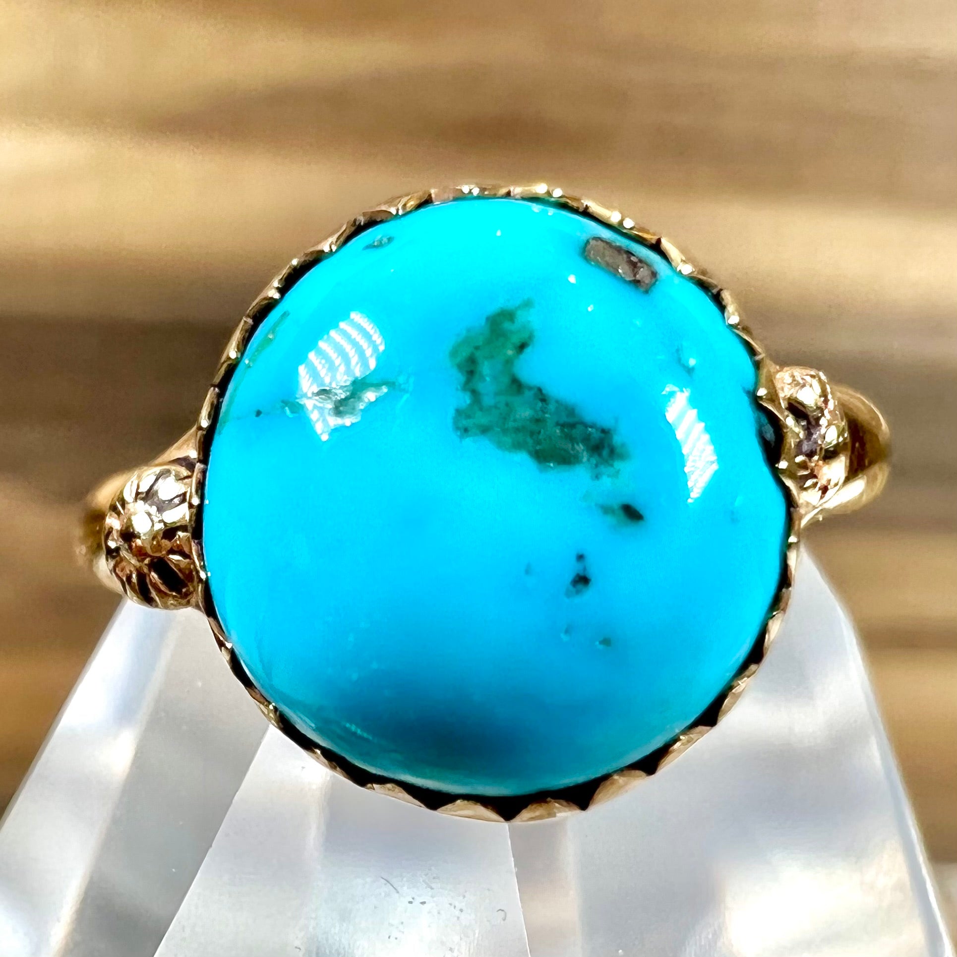 A ladies' yellow gold turquoise ring.  The turquoise is a round cabochon cut.