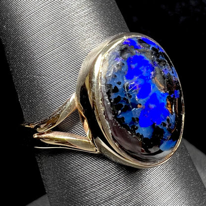 A handmade ladies' yellow gold boulder opal ring.  The opal is a natural purple Yowah nut boulder opal.