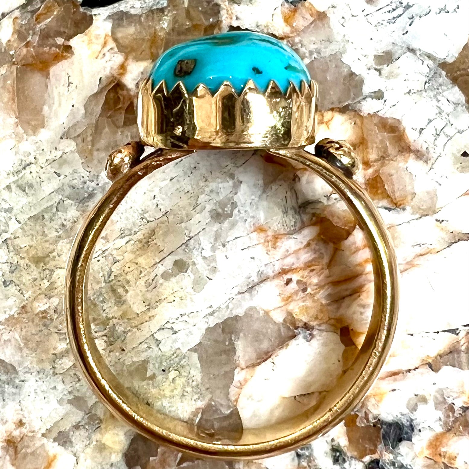 A ladies' yellow gold turquoise ring.  The turquoise is a round cabochon cut.