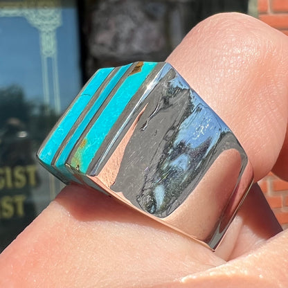 A men's turquoise ring inlay set with four turquoise stones.