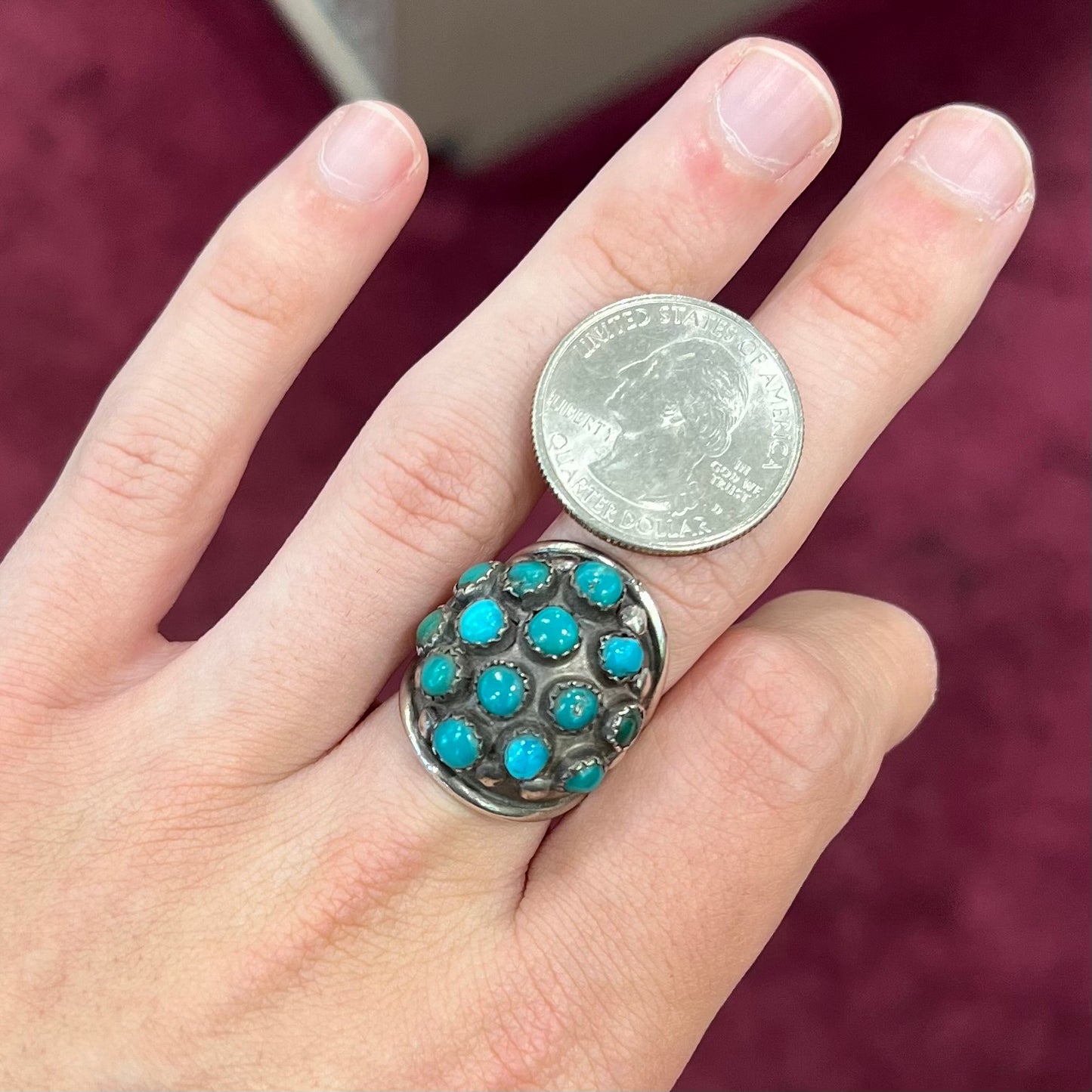 A handmade, unisex Hopi silver ring set with 14 round turquoise cabochons.
