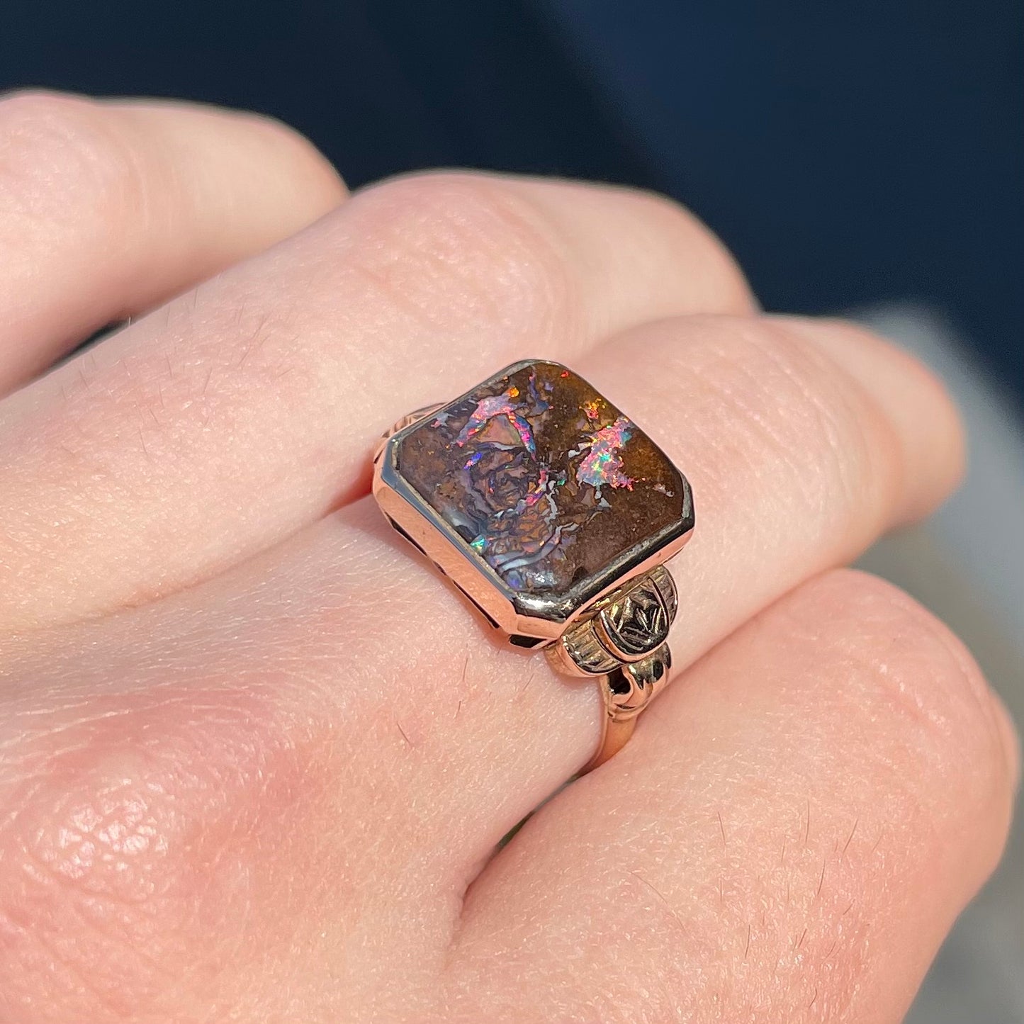 A square cut Australian boulder opal set in an antique ladies' yellow gold ring.