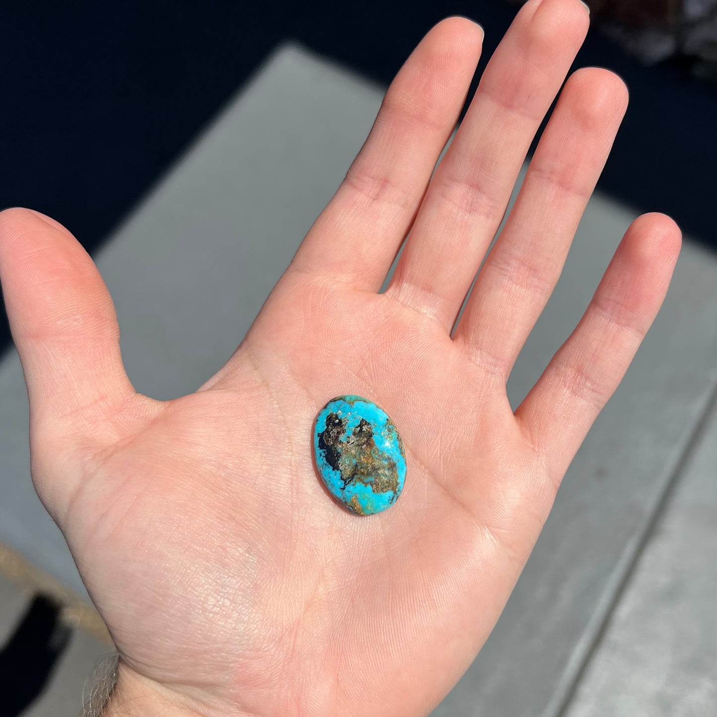 An oval cabochon cut Valley Blue turquoise stone.