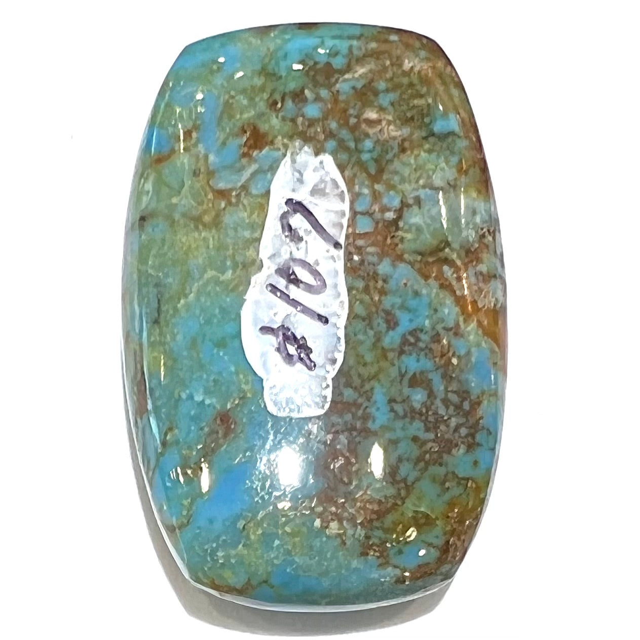 A loose, barrel cabochon cut turquoise stone from Manassa, Colorado.  The piece is blue with yellow matrix.