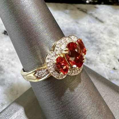 Past, present, future style red andesine feldspar and diamond halo ring cast in 14kt yellow gold.