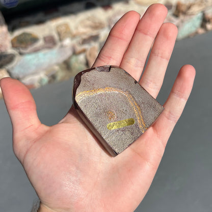 A polished piece of boulder opal stone from Koroit, Australia.