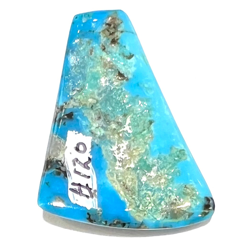 A loose, freeform triangle cabochon cut turquoise stone from the Sleeping Beauty Mine in Arizona.