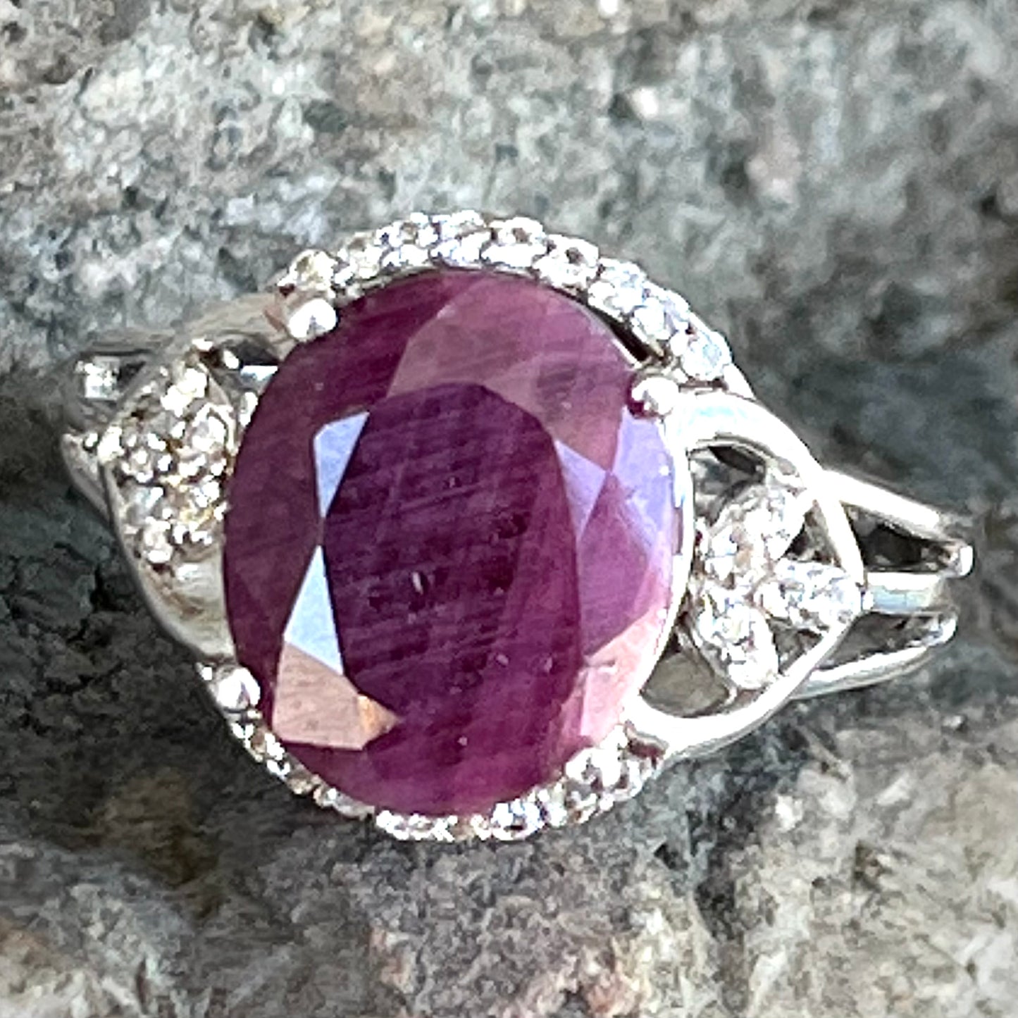 An oval cut natural ruby set in a sterling silver ring.