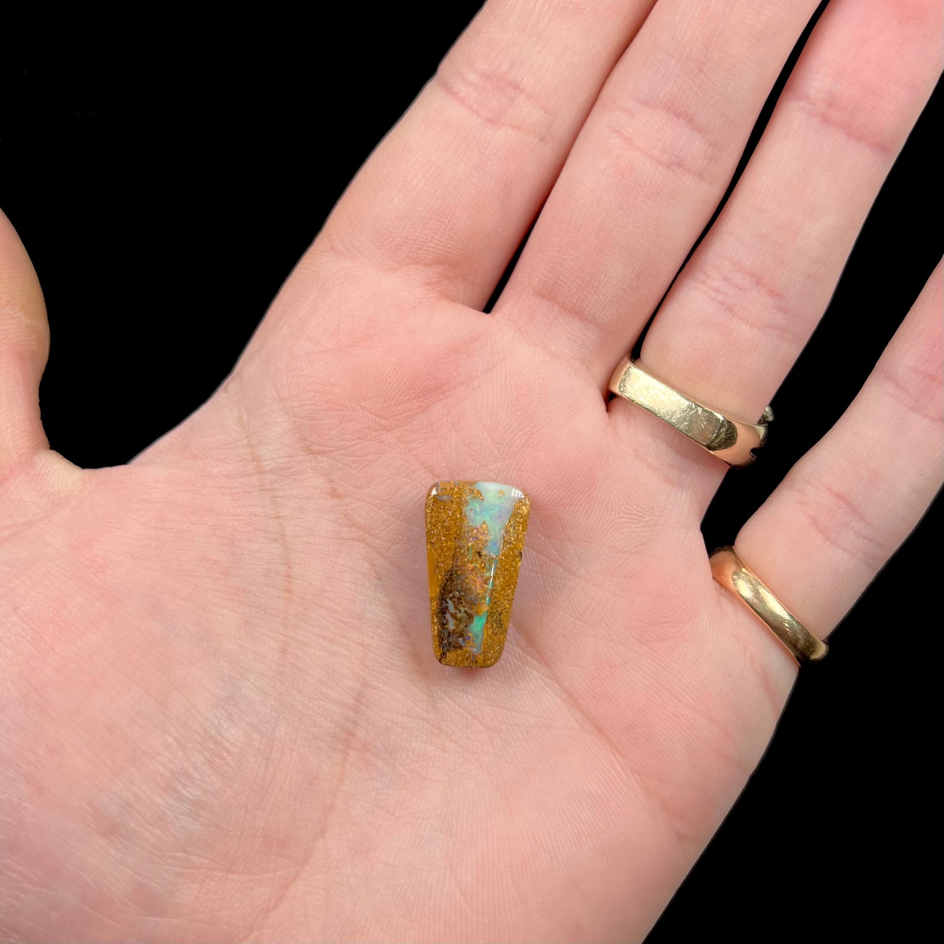 A polished, drilled pipe boulder opal bead.