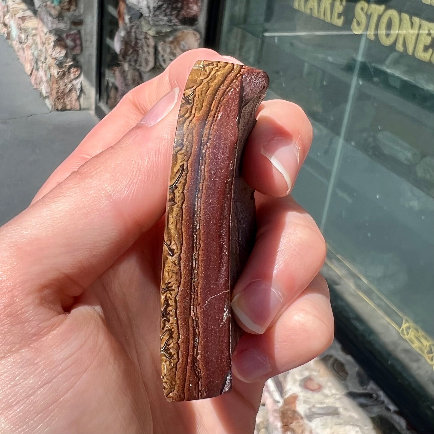 A polished piece of boulder opal stone from Koroit, Australia.