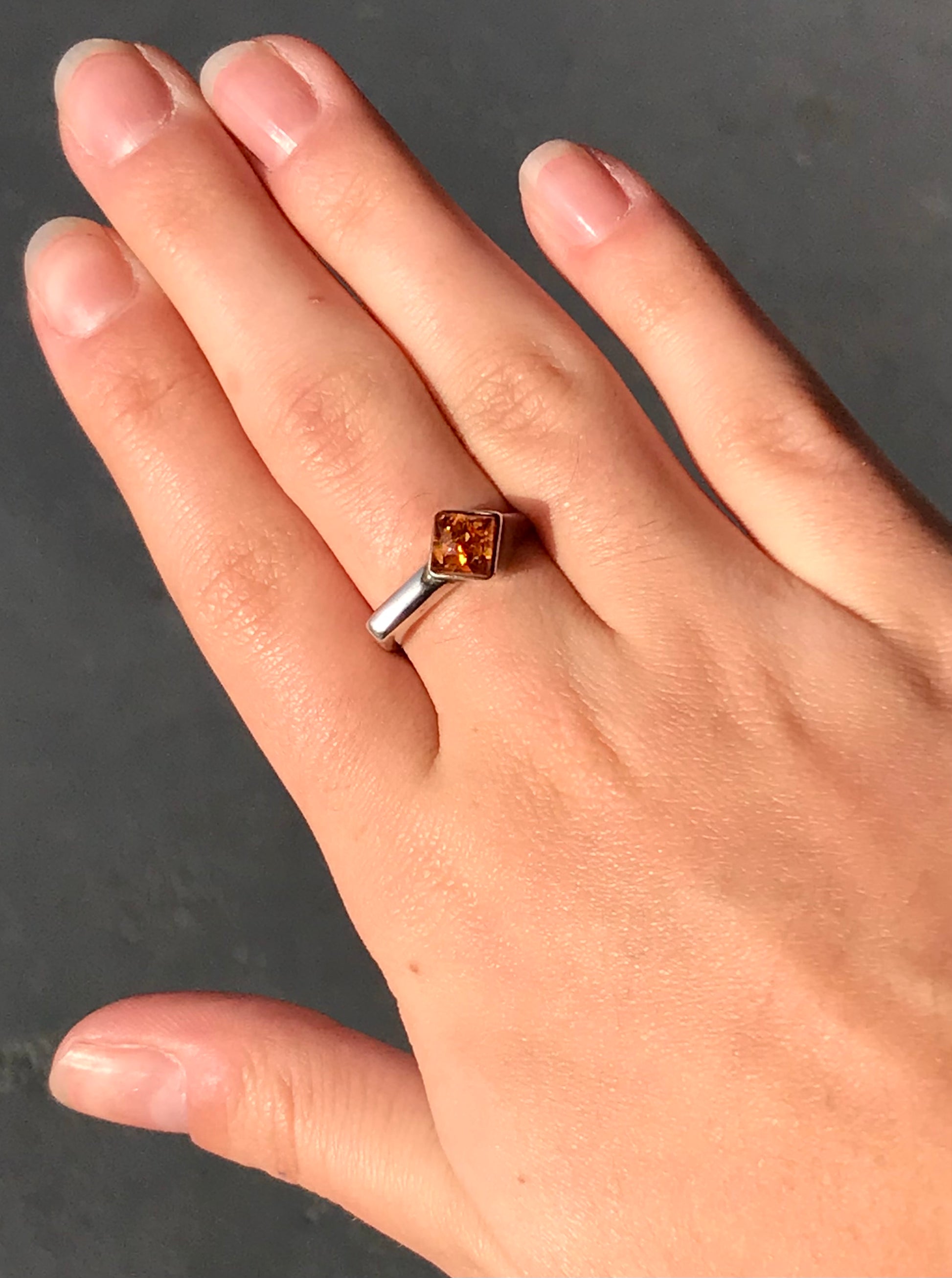 Square shaped Baltic Amber cabochon set in a unique sterling silver ring.