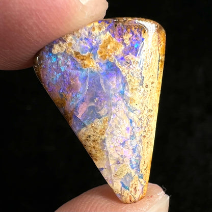 A polished, drilled pipe boulder opal bead.