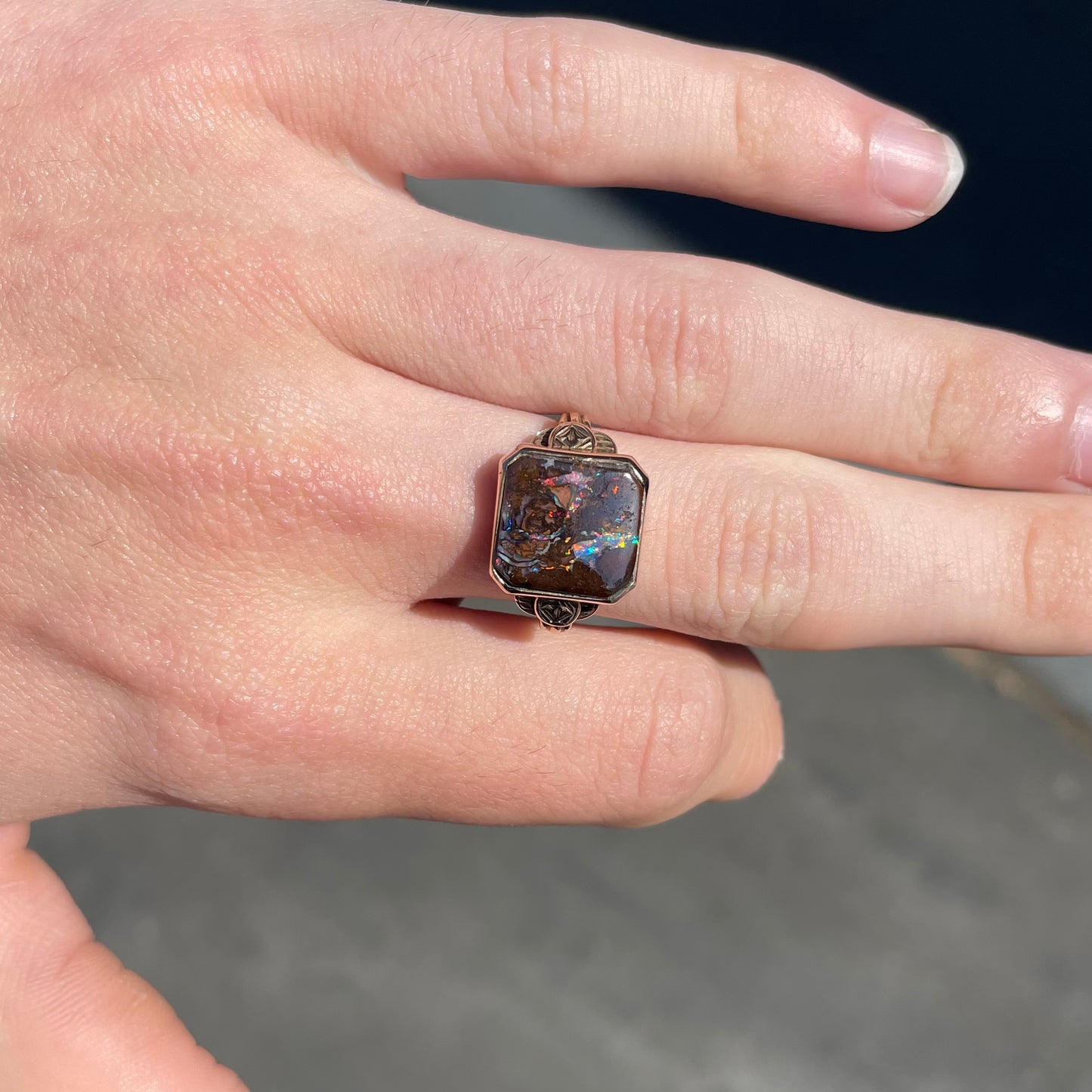 A square cut Australian boulder opal set in an antique ladies' yellow gold ring.