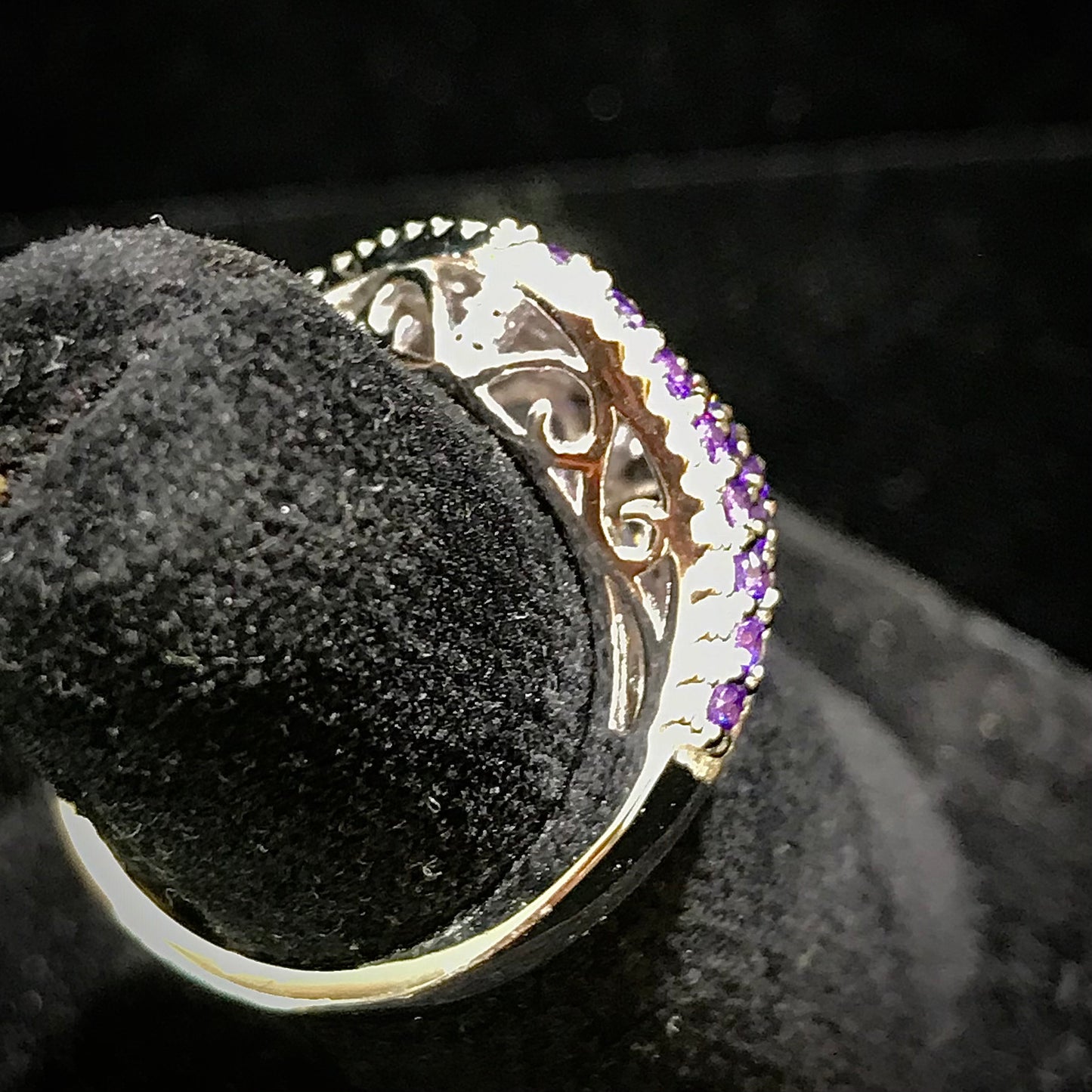 Purple synthetic ring set in sterling silver with white mele halo stones