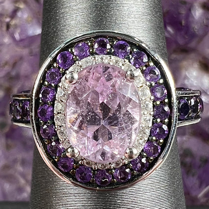 A sterling silver oval cut kunzite ring set with a double halo of round cut CZ and amethysts.