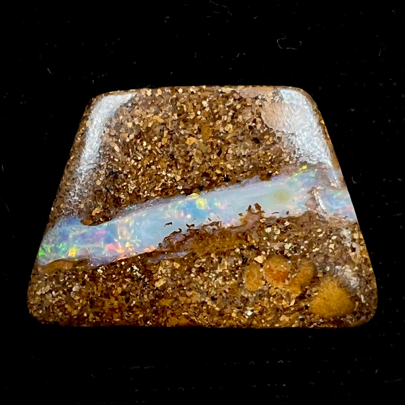 A polished, drilled pipe boulder opal bead.