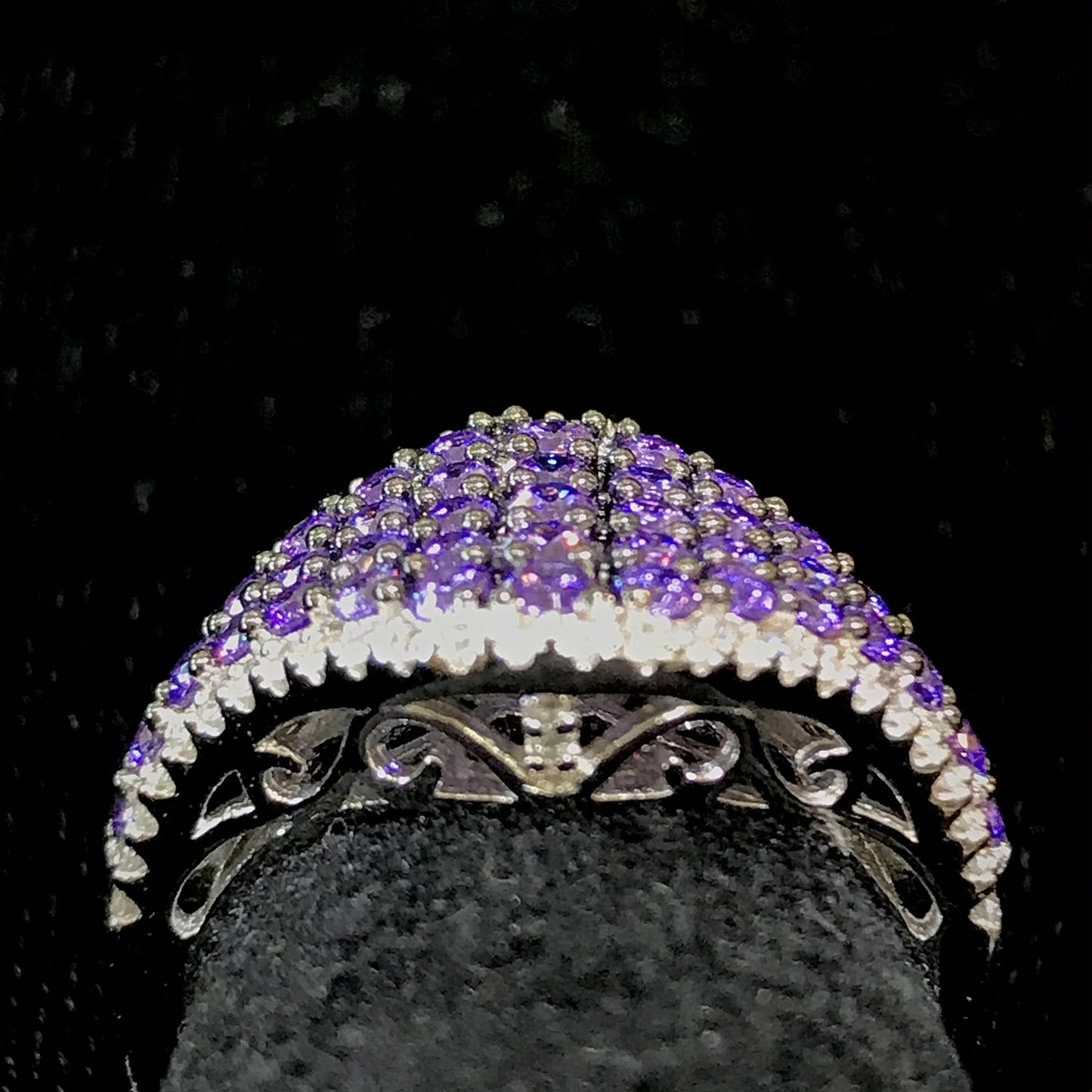 Purple synthetic ring set in sterling silver with white mele halo stones