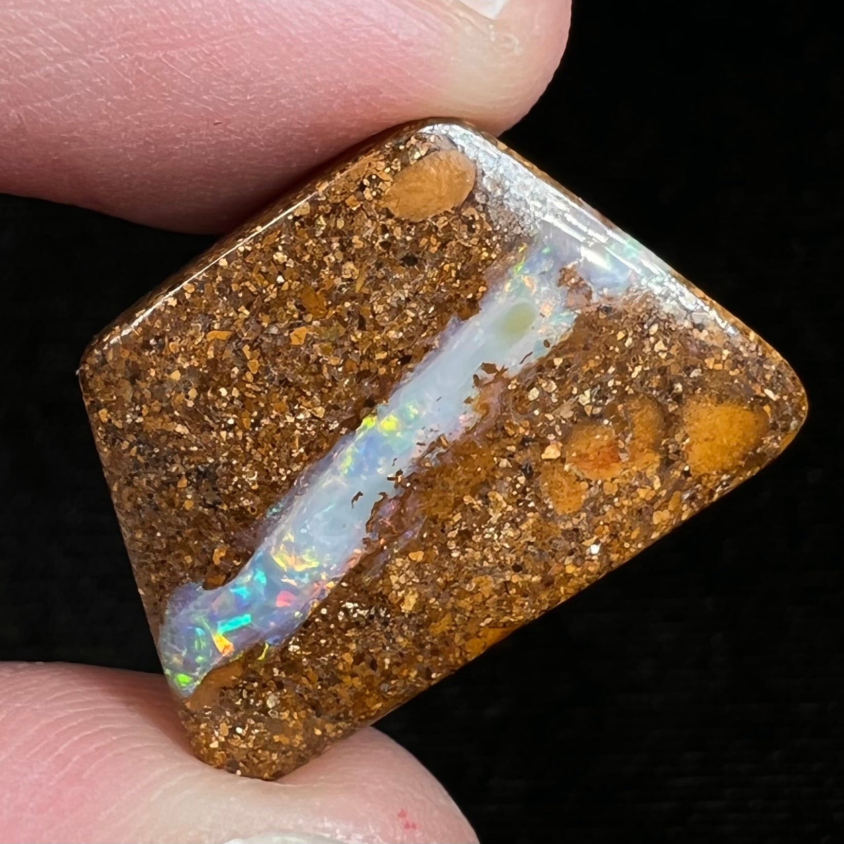 A polished, drilled pipe boulder opal bead.