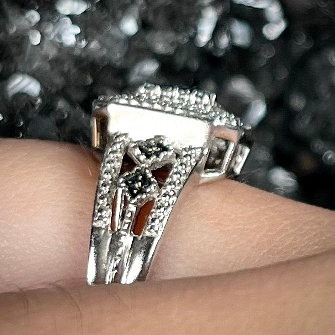 A sterling silver ring set with blue and white diamonds.