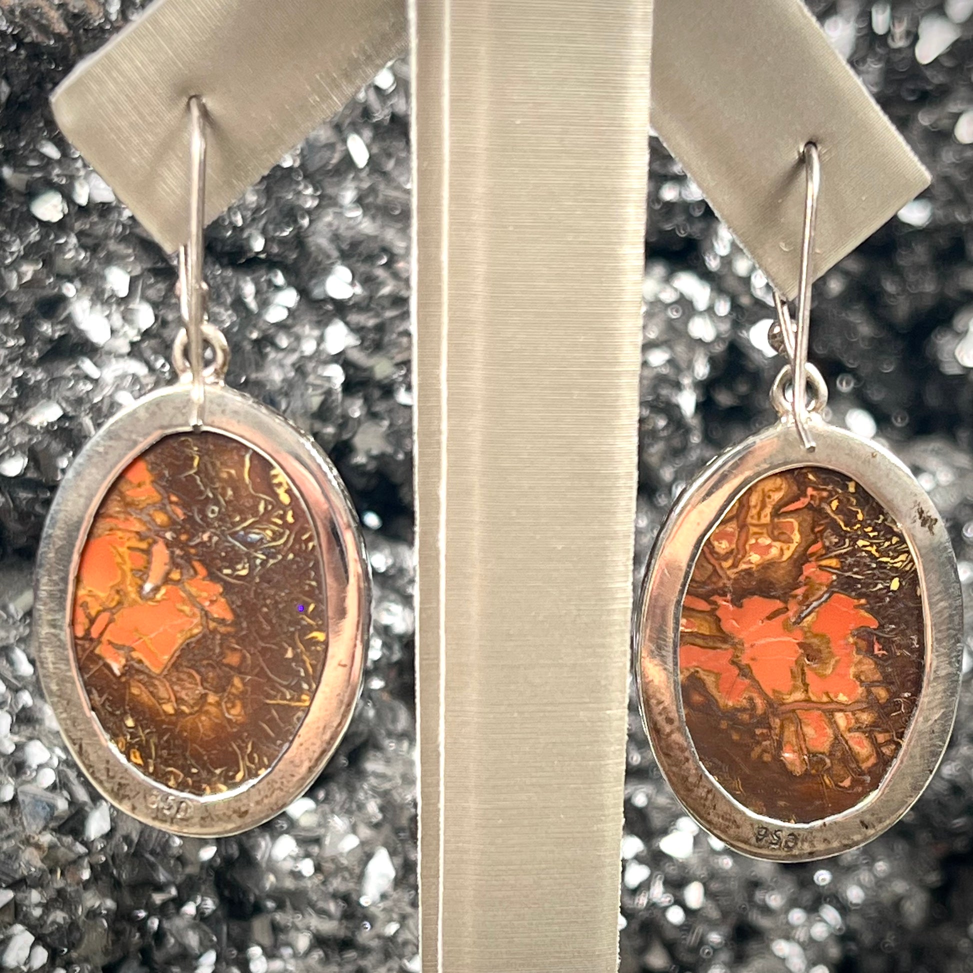 A pair of bezel set, French wire boulder opal dangle earrings in sterling silver.