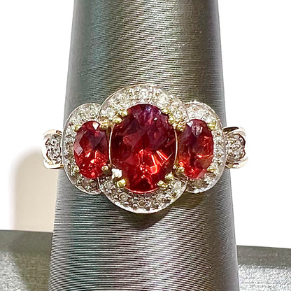 Past, present, future style red andesine feldspar and diamond halo ring cast in 14kt yellow gold.