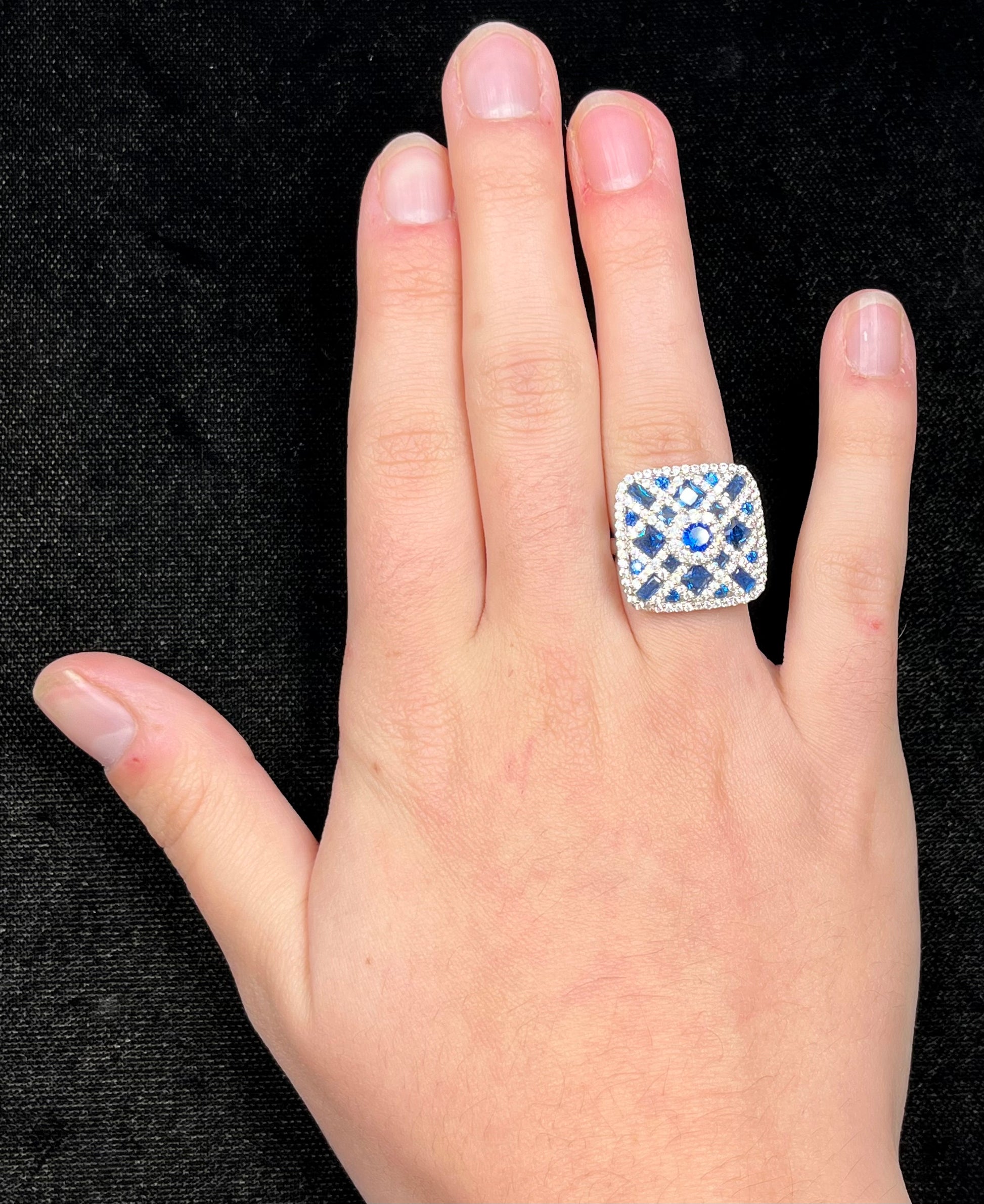 A sterling silver blue and white synthetic stone ring.  The ring strongly resembles a blueberry pie.