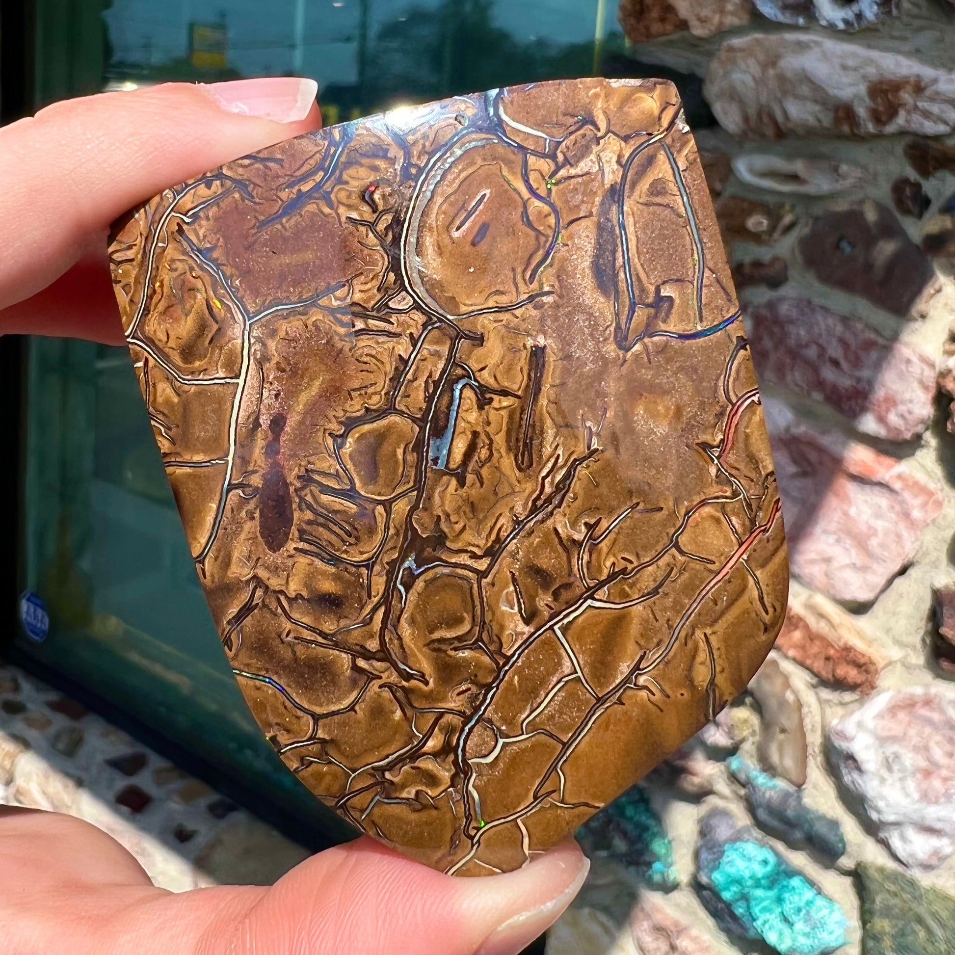 A polished piece of boulder opal stone from Koroit, Australia.