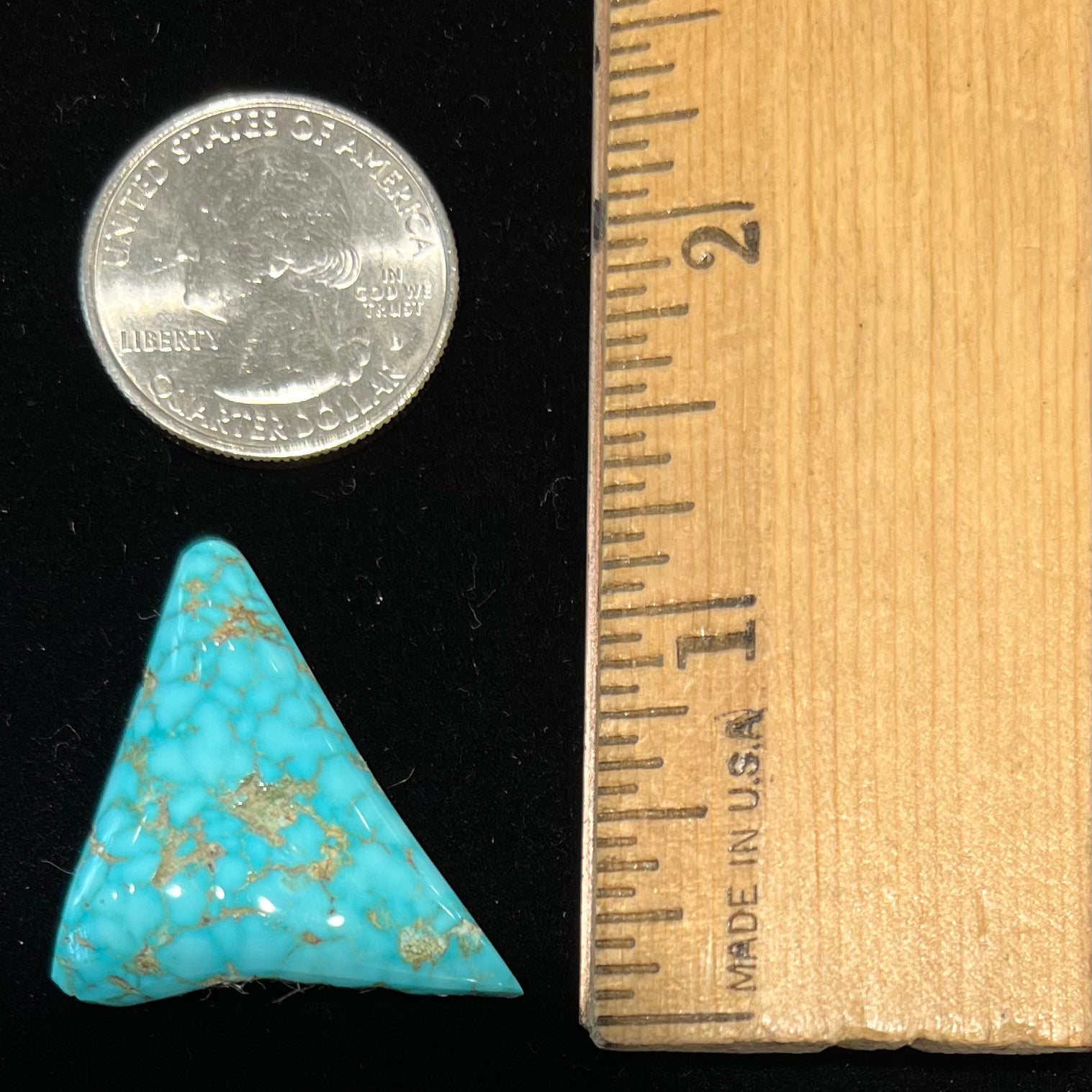 A polished triangular specimen of Bisbee, Arizona turquoise.