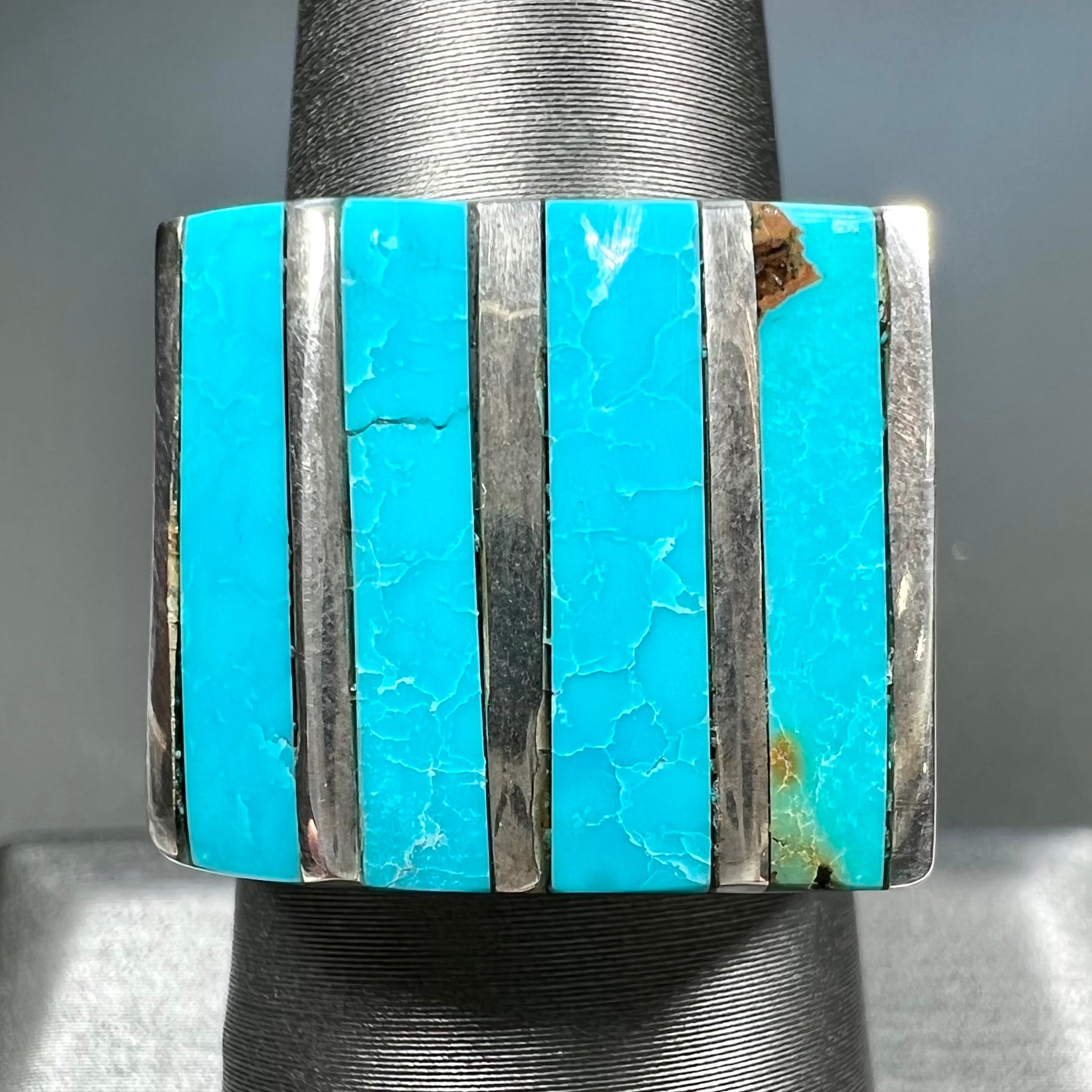 A men's turquoise ring inlay set with four turquoise stones.