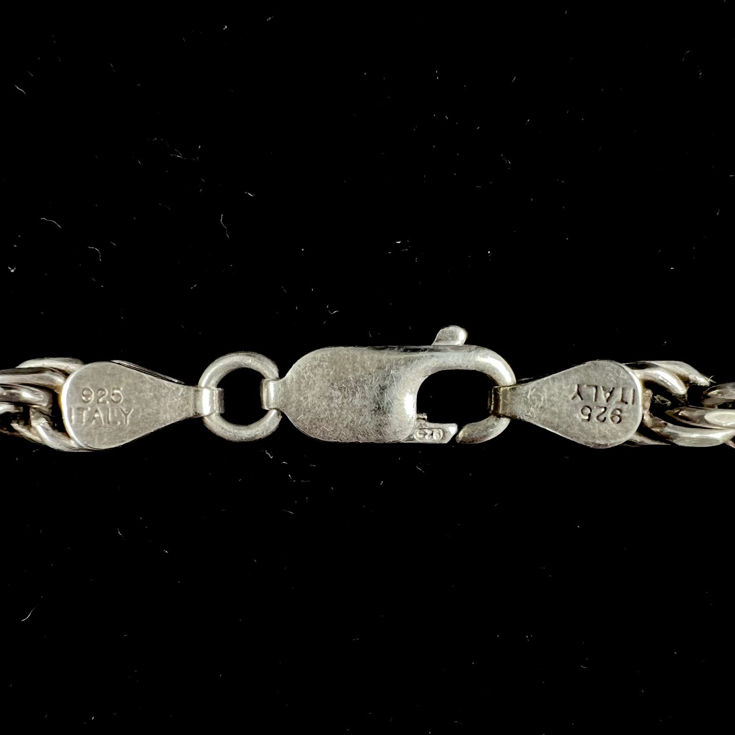 A men's sterling silver rope chain.  The chain measures 22 inches long and 4.5 millimeters wide.