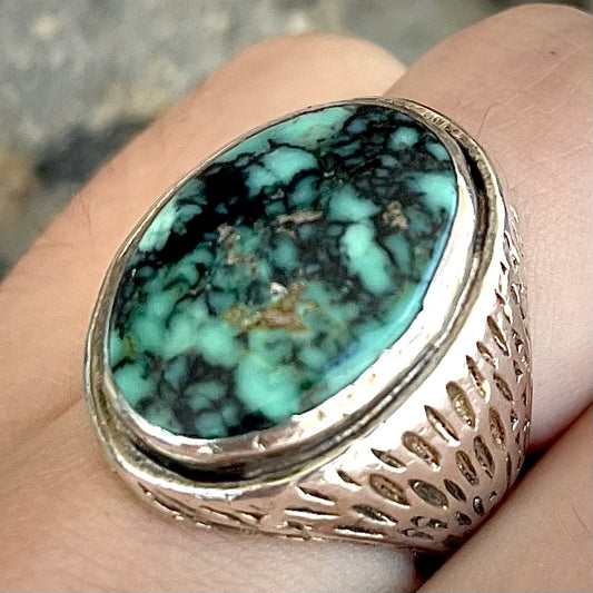 A sterling silver solitaire ring set with a black spiderweb turquoise stone from Kingman, Arizona.