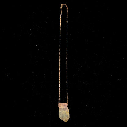 A drilled bicolor spodumene crystal hanging on a copper cable chain.  The crystal is pink and yellow, or kunzite and triphane respectively.