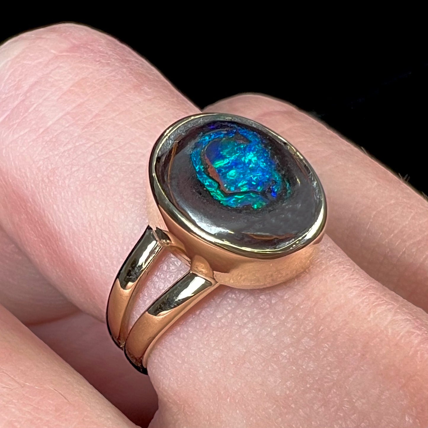 A natural Yowah Nut boulder opal split shank ring in 14kt yellow gold.