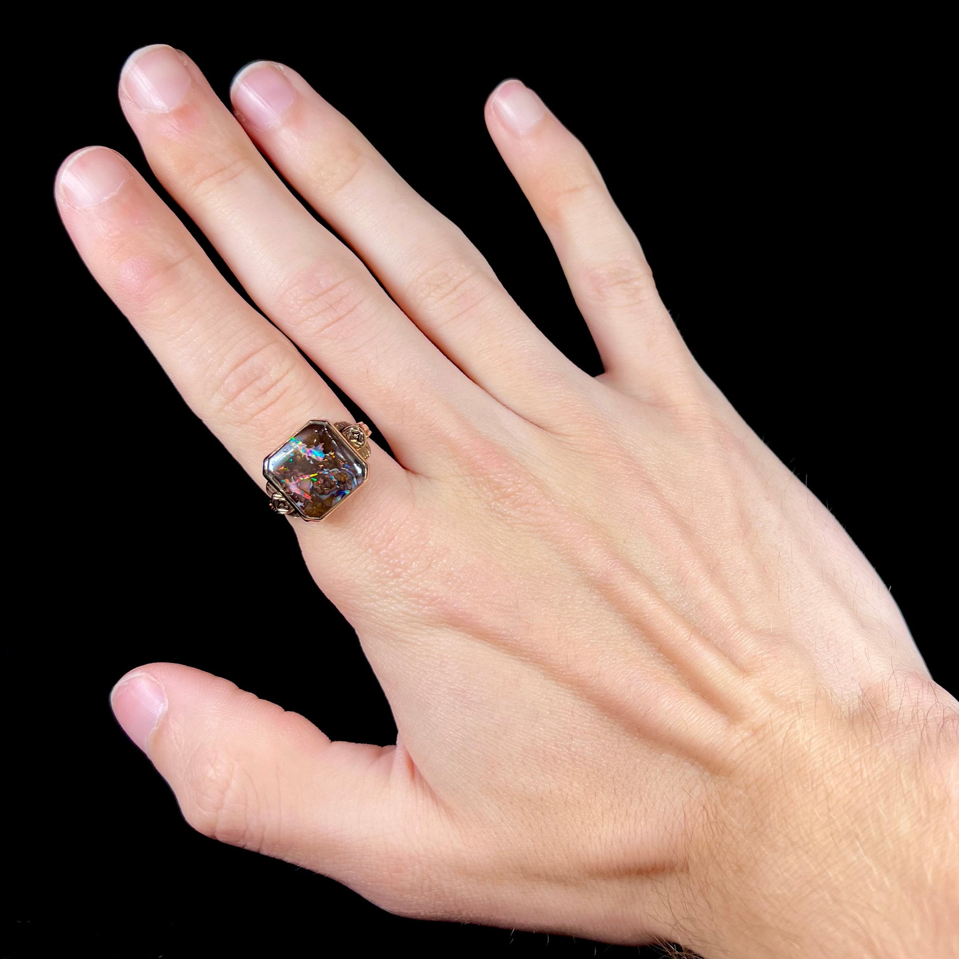 An antique yellow gold boulder opal ring.  The stone is a sqaure cut natural opal from Quilpie, Australia.