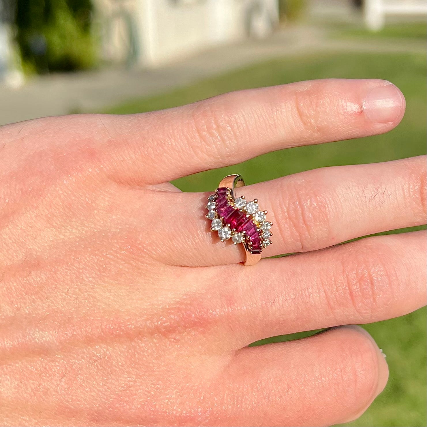 A yellow gold ladies' ring set with 12 baguette cut rubies and 12 Standard Round Brilliant Cut diamonds.