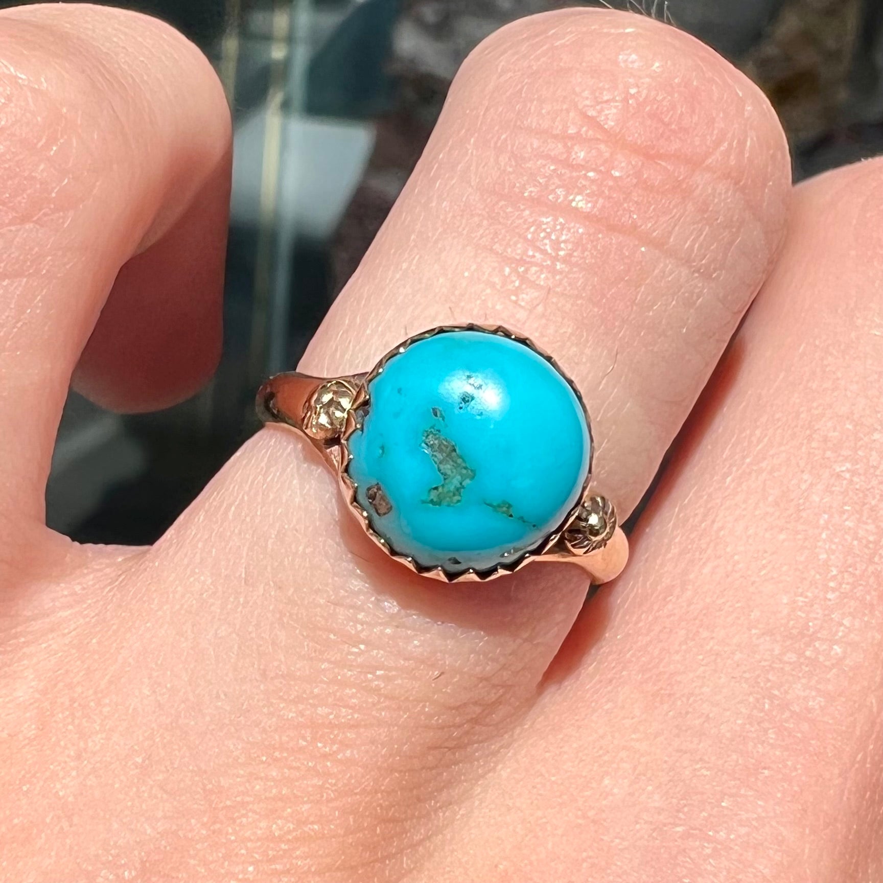 A ladies' yellow gold turquoise ring.  The turquoise is a round cabochon cut.