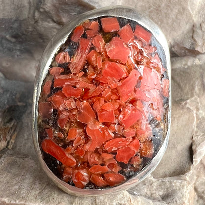 A rustic style, handmade silver men's ring set with crushed red coral.