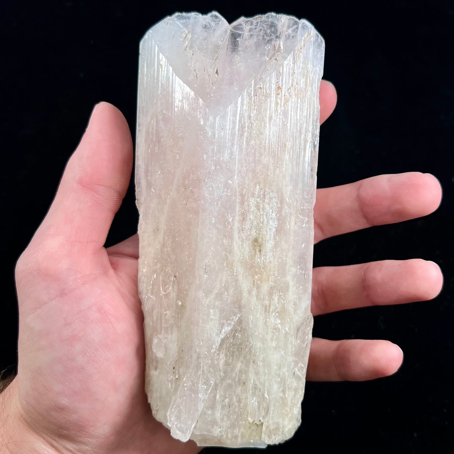 A 5.5 inch long pink danburite crystal that weighs over one pound.