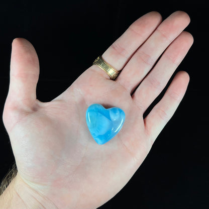 An AAA+ grade larimar stone cut into a heart shaped cabochon.