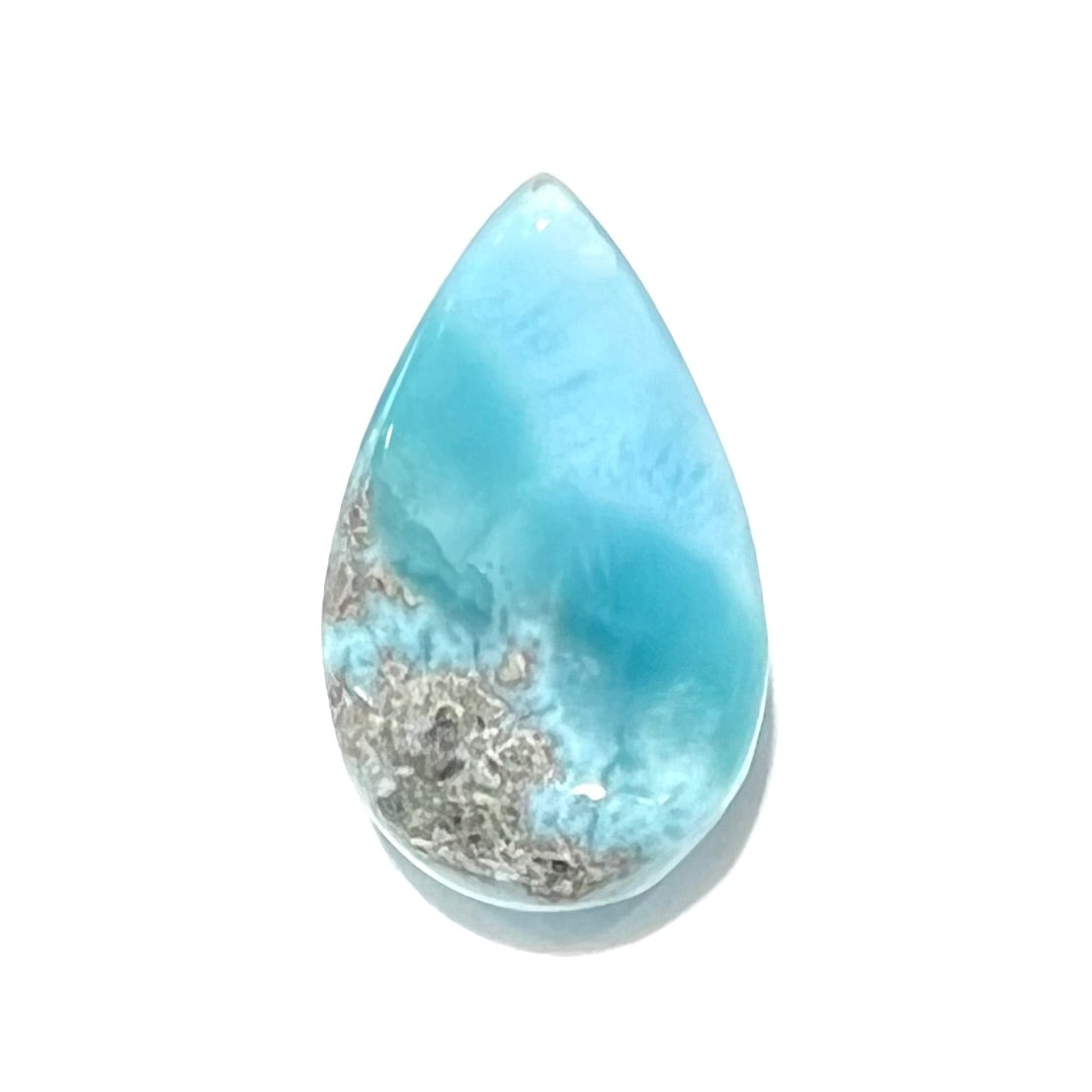 A loose, pear shaped, cabochon cut larimar stone from Dominican Republic.