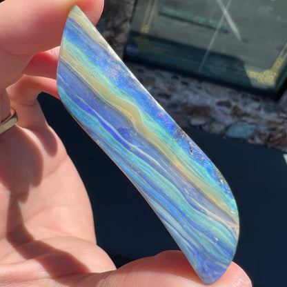 A large, loose, polished Quilpie boulder opal stone from Queensland, Australia.  The stone is blue.