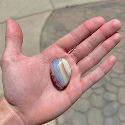 A loose, drop shaped Australian boulder opal from Quilpie Mining District.