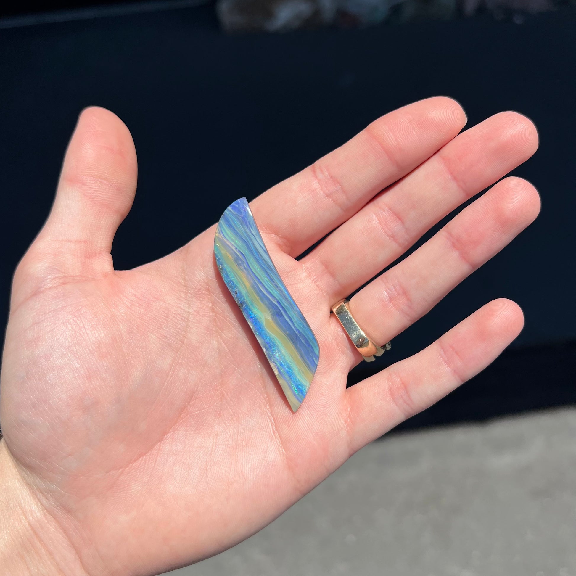 A large, loose, polished Quilpie boulder opal stone from Queensland, Australia.  The stone is blue.