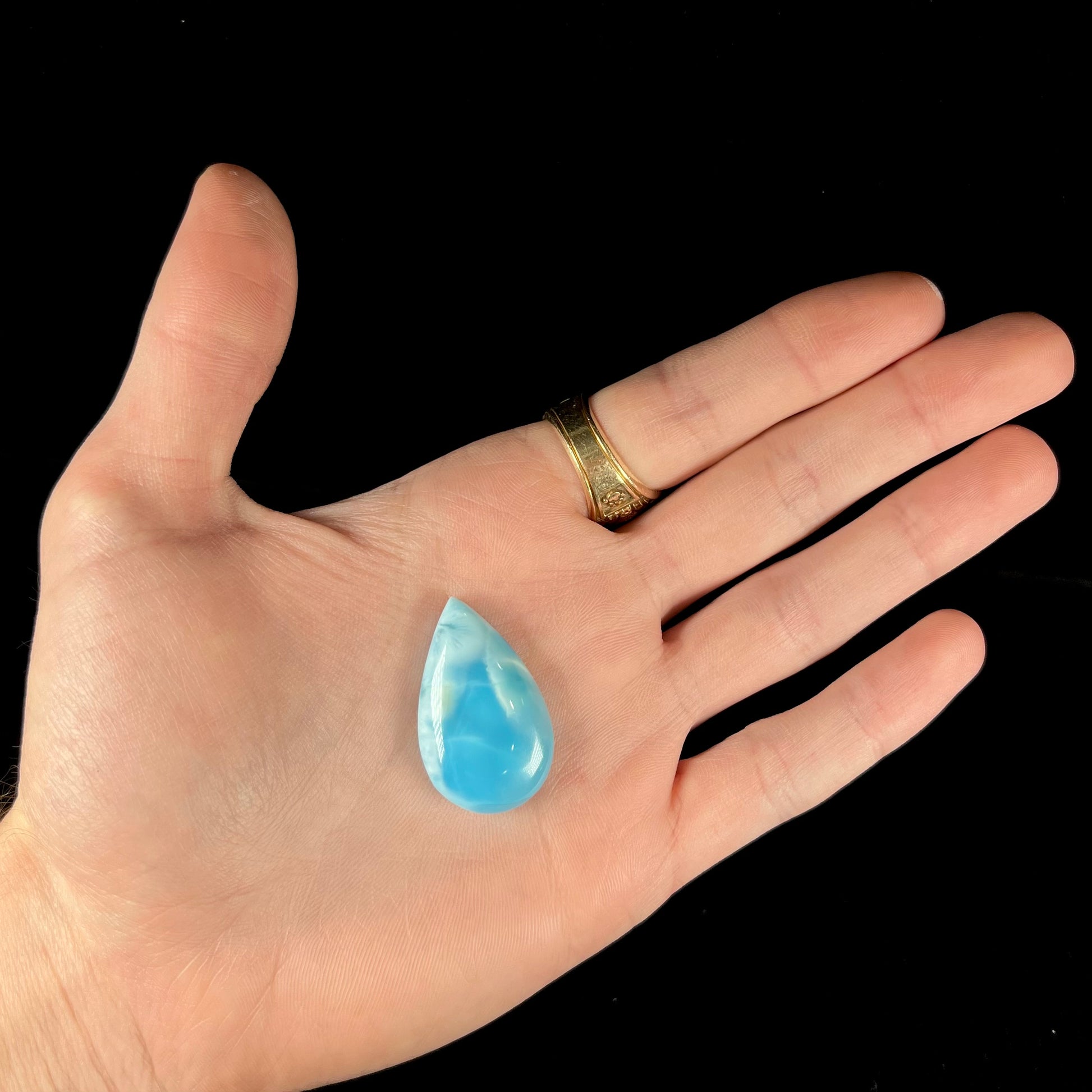 A loose, AAA+ grade, pear shaped cabochon cut blue larimar stone from Dominican Republic.