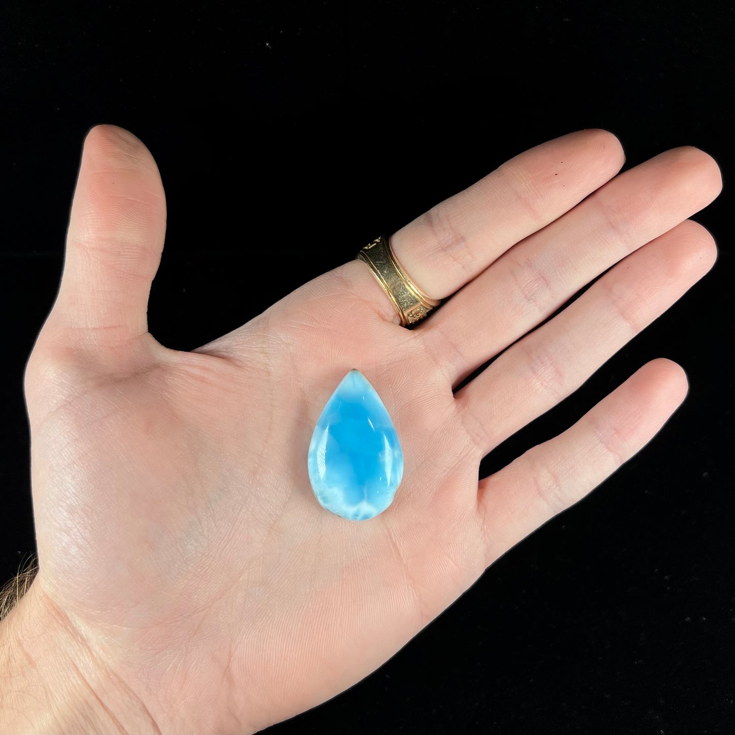 A loose, pear shaped larimar cabochon from Dominican Republic.  The stone is AAA+ grade.