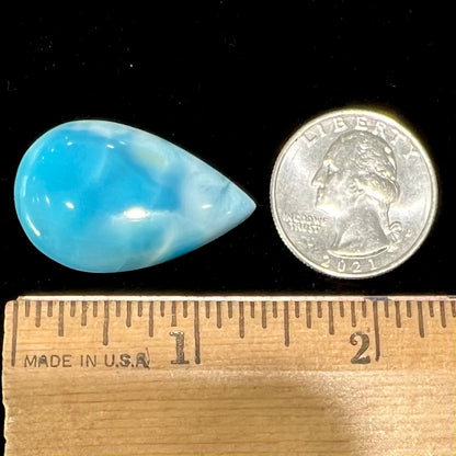 A loose, AAA+ grade, pear shaped cabochon cut blue larimar stone from Dominican Republic.