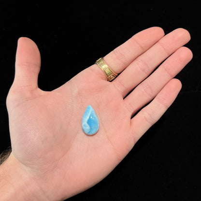 A loose, pear shaped, cabochon cut larimar stone from Dominican Republic.